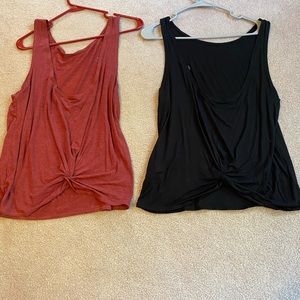 Zyia swirl tanks, size large. One red, one black